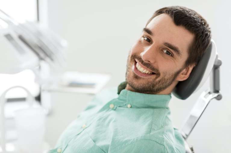 A man smiling after recovering from an Emergency Dental visit in Randolph, NJ